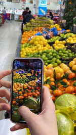 Cropped hands of woman using mobile phone