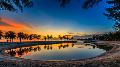 Scenic view of lake against sky during sunset