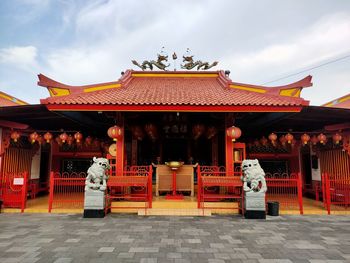 Rear view of woman standing in temple