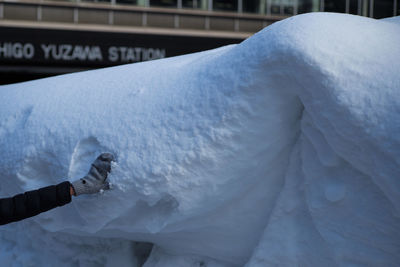 Close-up of hand on snow