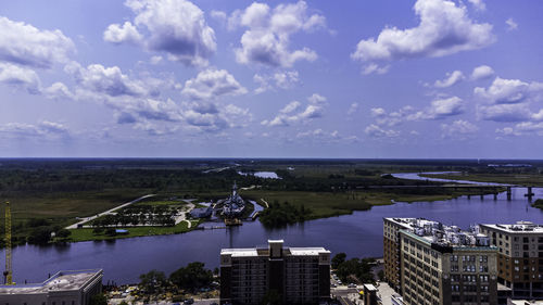 High angle view of buildings by sea against sky