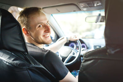 Portrait of man sitting in car