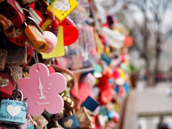 Close-up of multi colored padlocks hanging outdoors