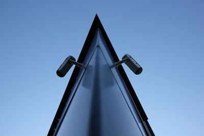 Low angle view of cross against clear blue sky