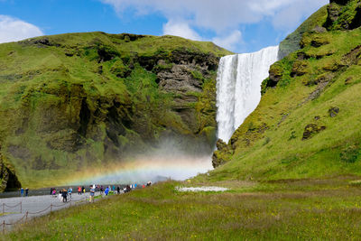 Group of people on mountain against the sky