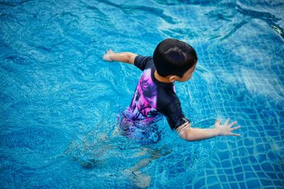 High angle view of boy swimming in pool