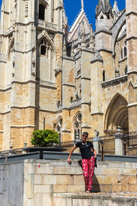 Woman smiling in front of the cathedral of leon in spain