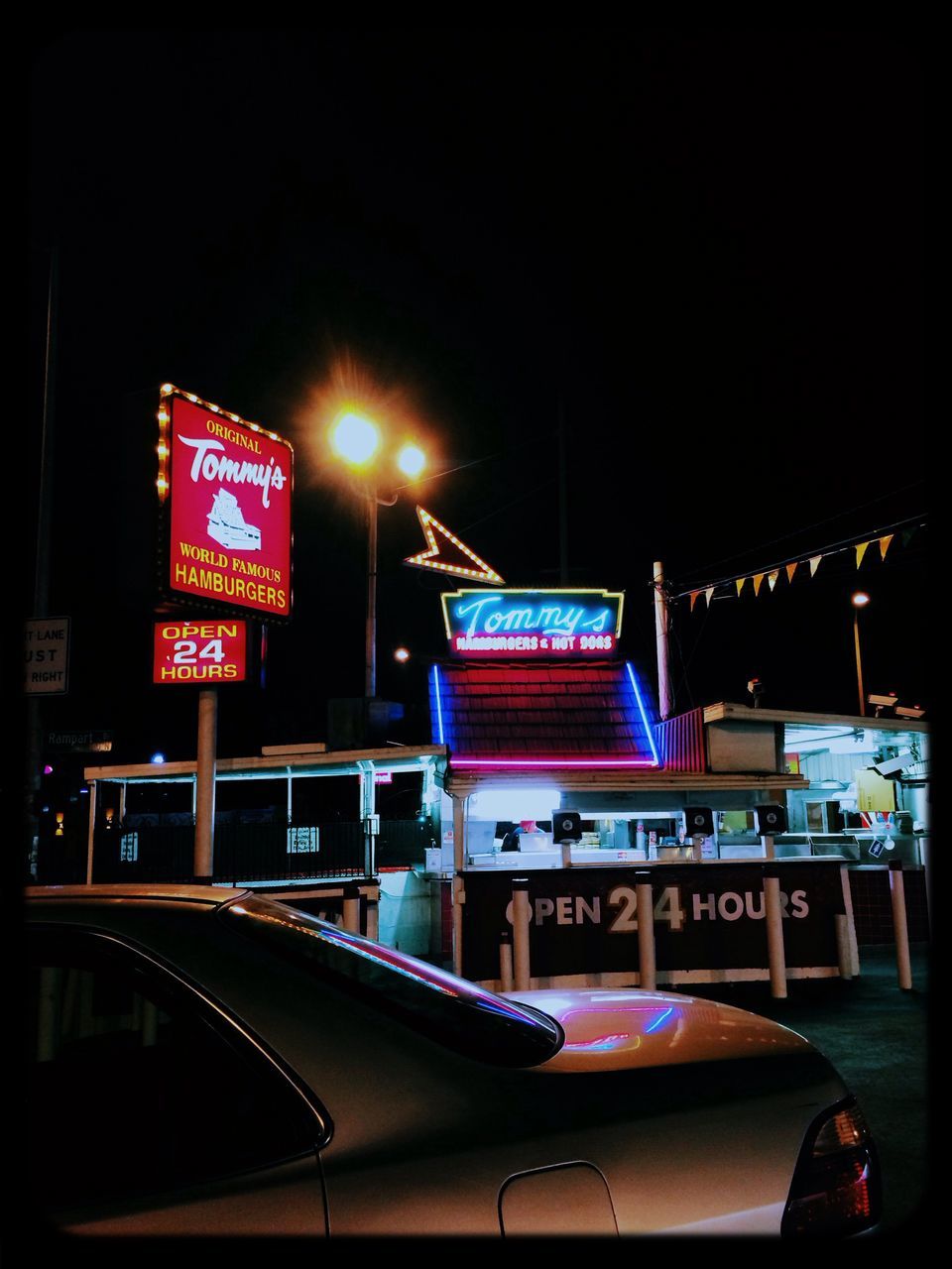 illuminated, night, text, western script, communication, transportation, built structure, architecture, building exterior, street, city, sign, clear sky, information sign, capital letter, copy space, road, lighting equipment, advertisement, information