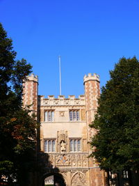 Low angle view of historic building against clear blue sky