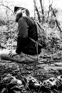 Rear view of man sitting in the forest