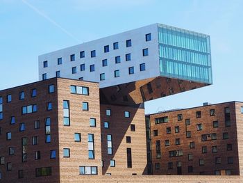 Low angle view of modern building against clear blue sky