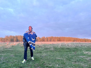 Full length of man standing on field against sky