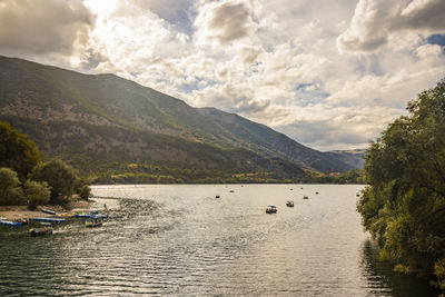 Scenic view of lake and mountains against sky