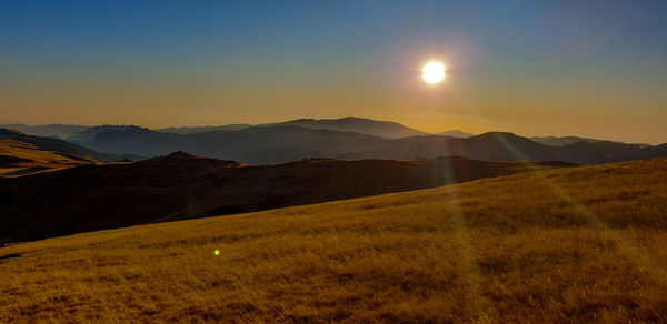 Scenic view of mountains against sky during sunset