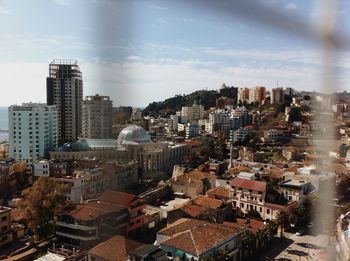 Buildings against cloudy sky