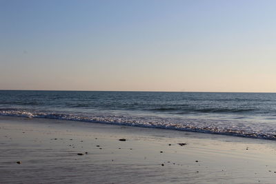 Scenic view of sea against clear sky during sunset