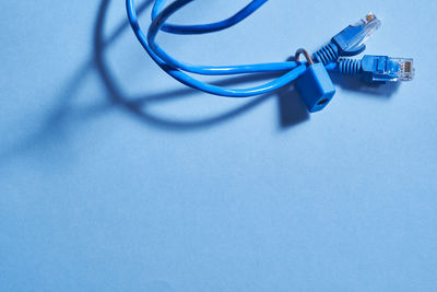 Close-up of in-ear headphones on blue background