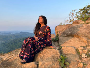 Portrait of woman standing on rock