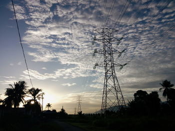 Low angle view of electricity pylon against sky