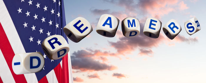 Close-up of information sign against blue sky