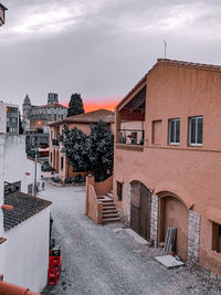 Street amidst buildings in city against sky