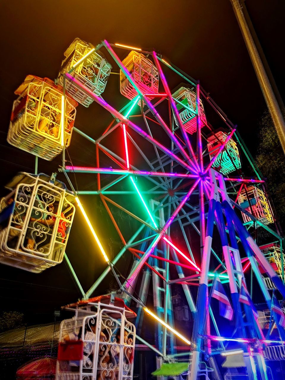 multi colored, illuminated, no people, ferris wheel, amusement park, night, low angle view, amusement park ride, glowing, arts culture and entertainment, indoors, large group of objects, pattern, art and craft, creativity, built structure, architecture, close-up, decoration, communication, nightlife