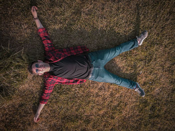 High angle view of person lying on field