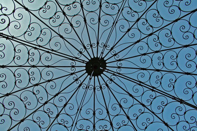 Full frame shot of metal design on window against clear blue sky