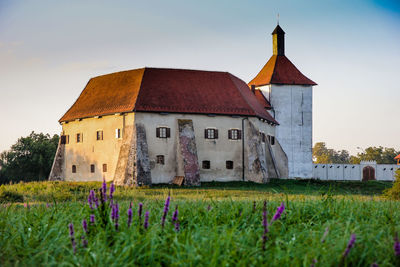 House on field against sky