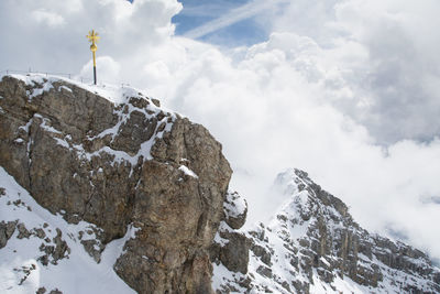 Low angle view of snowcapped mountains against sky