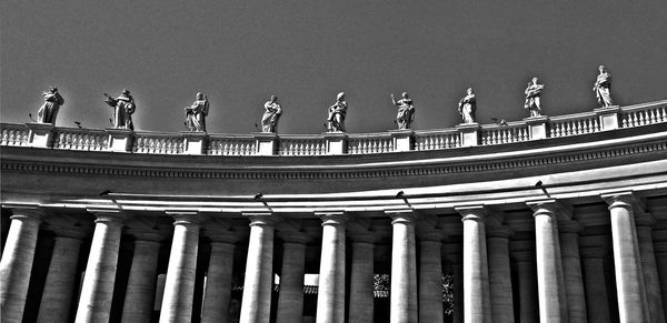 Low angle view of statues at st peter basilica against clear sky