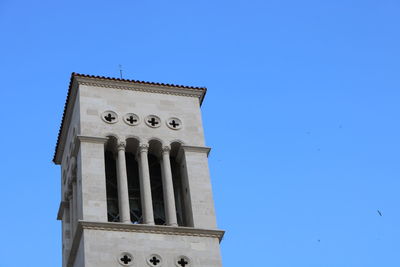 Low angle view of building against clear blue sky