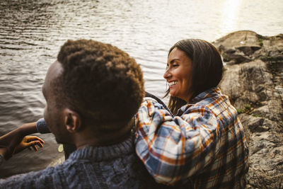 Portrait of smiling man and woman at sea shore