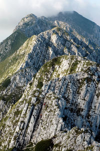 Spectacular mountain limestone ridge, piatra craiului, carpathians, romania. climbers in the wall