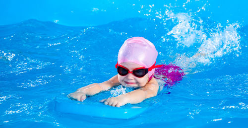 Portrait of woman swimming in pool