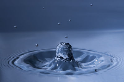 Close-up of water drop rising again after dipping into water