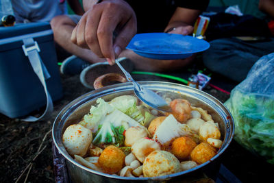 Cropped hand having food