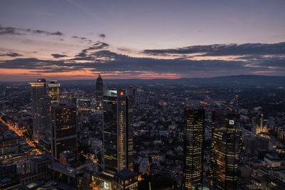 Aerial view of city lit up at sunset