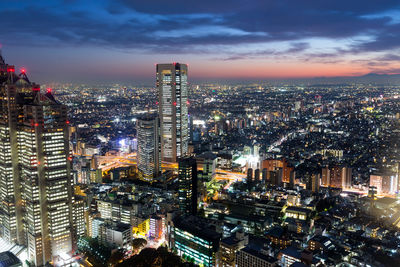 High angle view of illuminated cityscape against sky during sunset