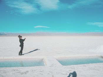 Full length of woman standing against clear sky