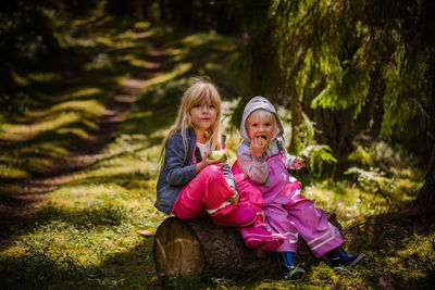 Rear view of mother and daughter on field