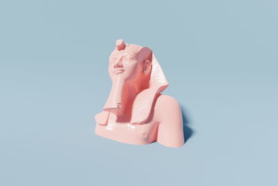 Close-up of figurine against blue background