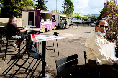 People sitting on table by chairs