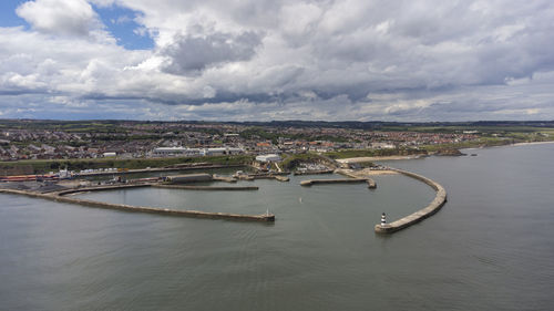 Aerial shot above seaham lighthouse and pier in 4k, durham, uk