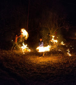 Illuminated fire on field at night