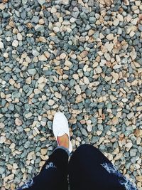 Low section of person standing on tiled floor