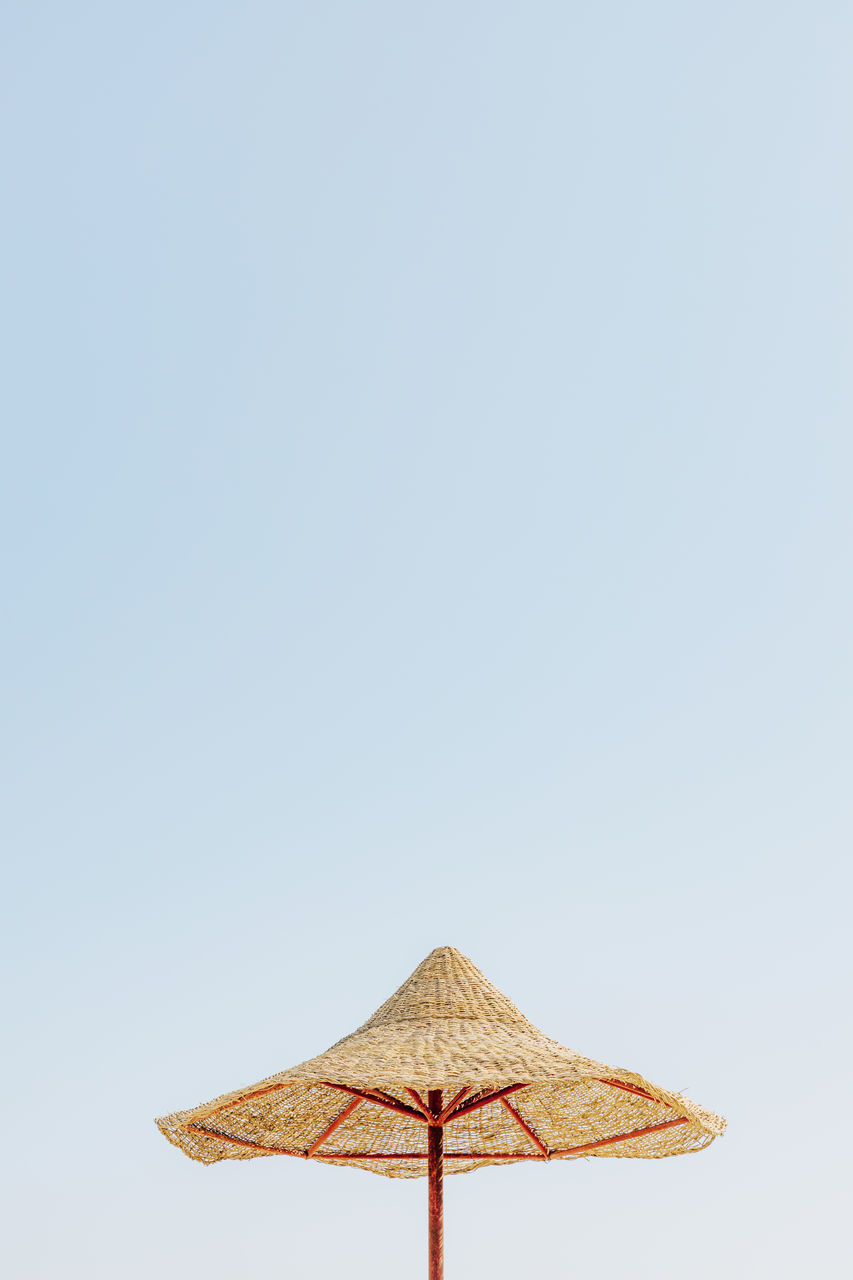 LOW ANGLE VIEW OF PARASOL AGAINST CLEAR SKY