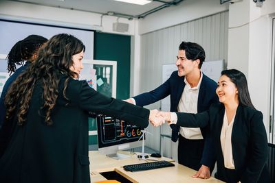 Side view of business colleagues working in office