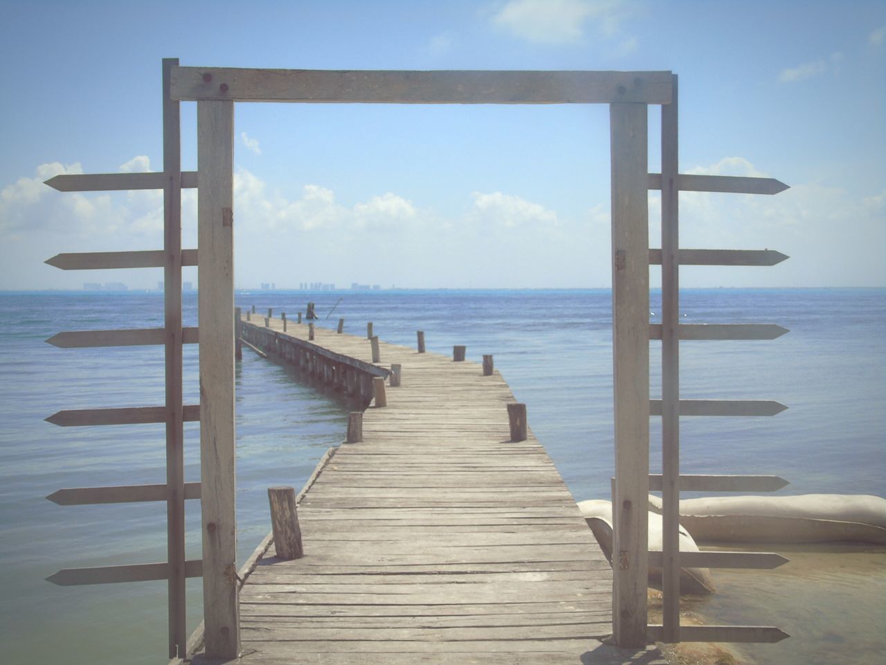 sea, horizon over water, water, sky, pier, tranquil scene, tranquility, scenics, beach, beauty in nature, wood - material, blue, the way forward, nature, jetty, idyllic, shore, cloud, railing, wood