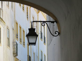 Low angle view of street light mounted on building